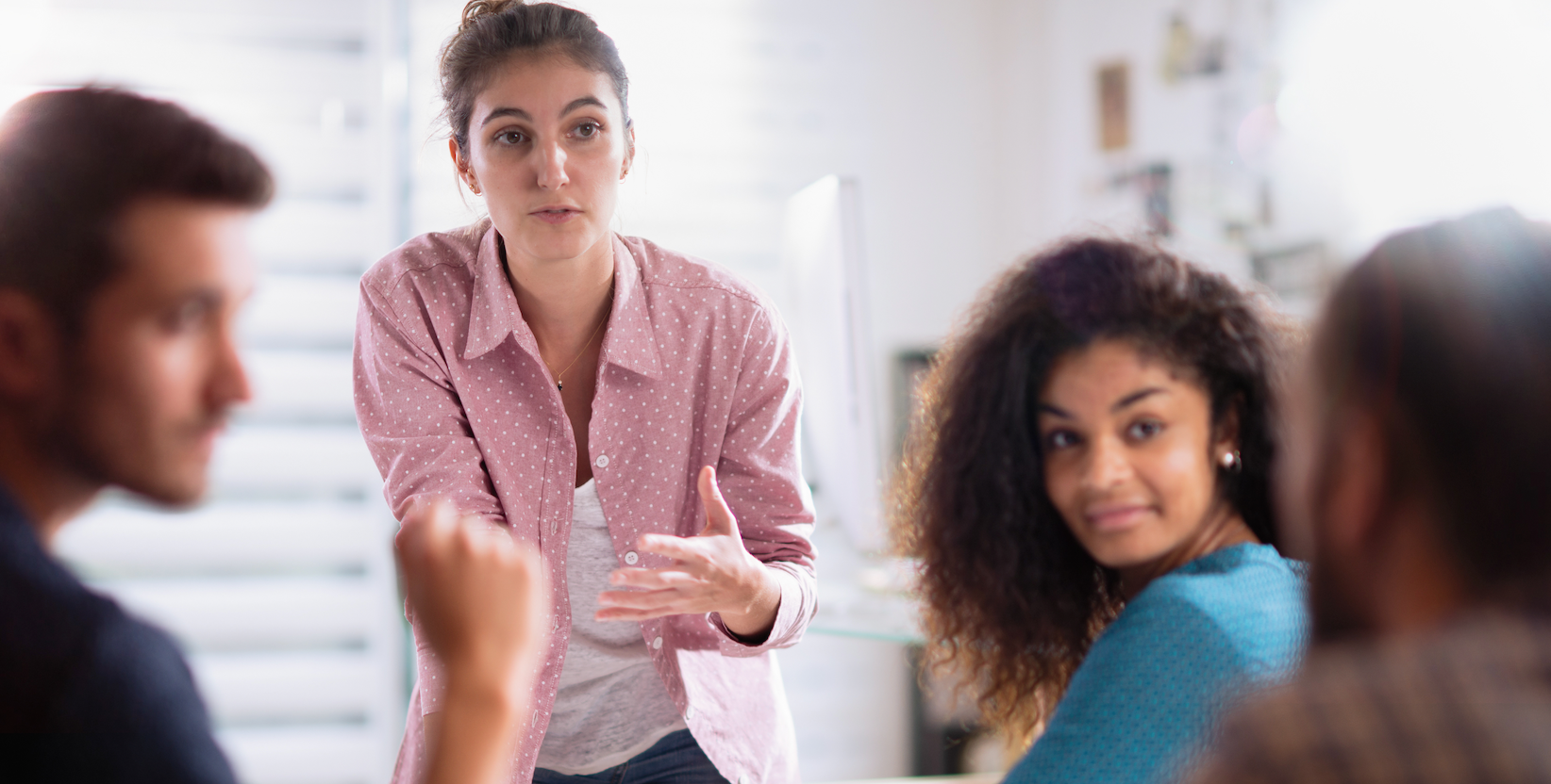 Diverse people having discussion in meeting room