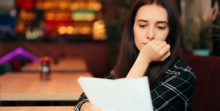 Women reading paper while sitting in restaurant