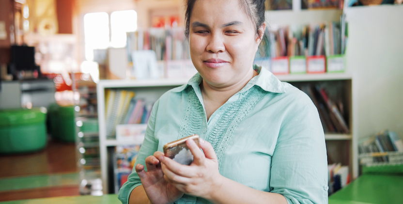 Women with vision impairment holding smartphone