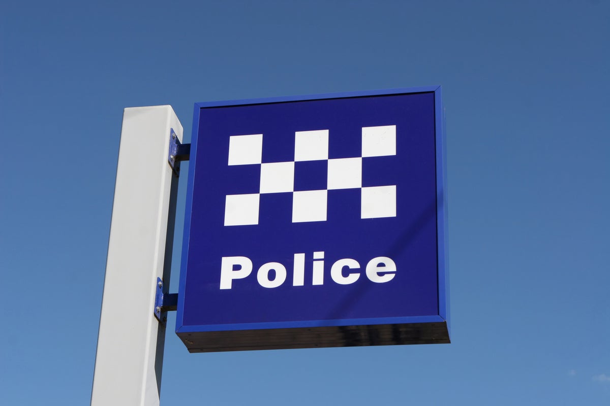 Blue and quite chequered police sign