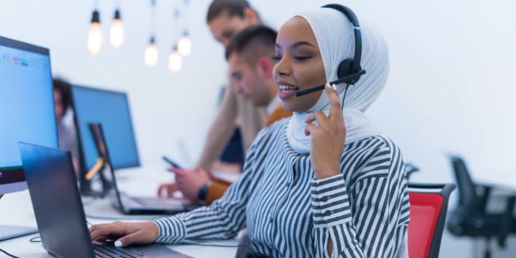 Women answering phone in call centre