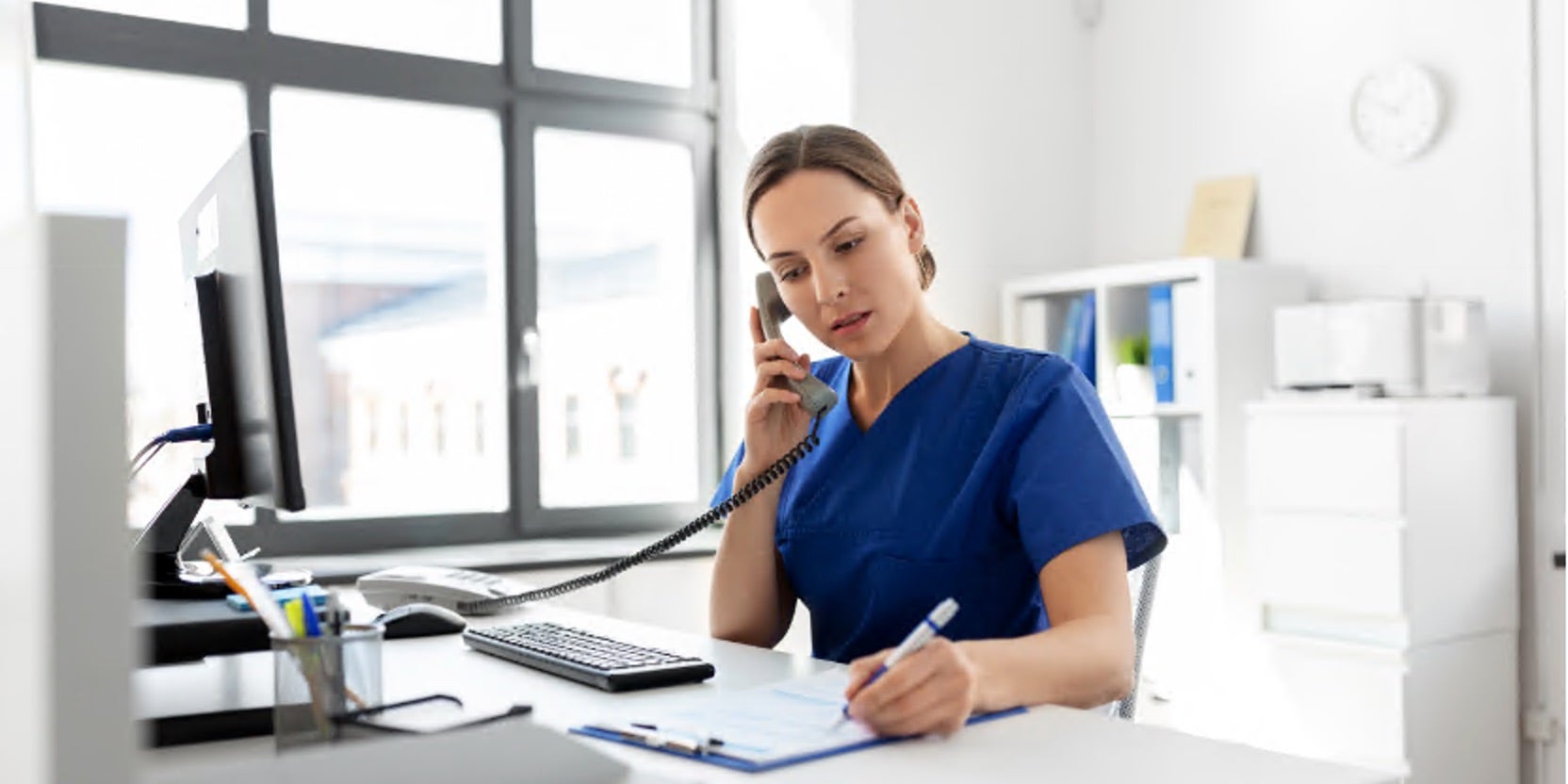 Women in medical uniform answering phone