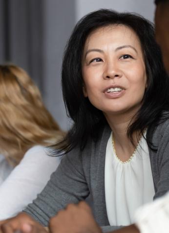 Women talking with colleagues in boardroom setting